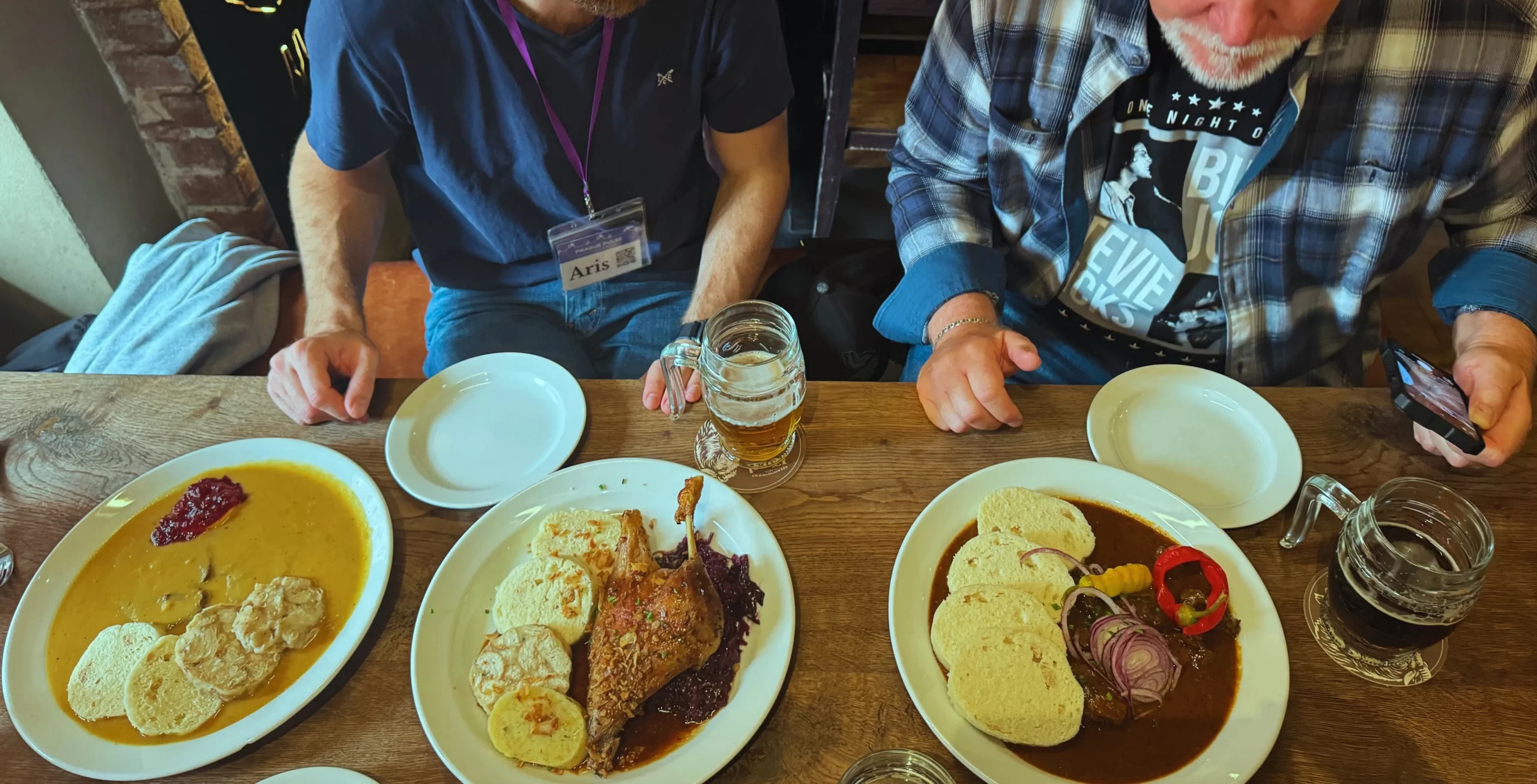 people on prague food tour enjoying food & beer